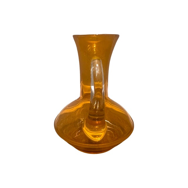 We have for your consideration a very beautiful vintage mid century modern orange glass pitcher in a beautiful...