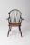 This is an antique Windsor arm chair with rush seat. The bow back Windsor chair features a back brace and beautiful rush...