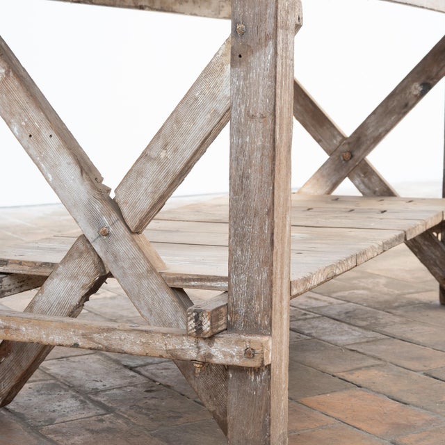 This antique workshop table, dating from the early 20th century, is crafted from fir and oak and boasts a remarkable...