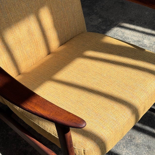 This mid-century easy chair embodies the clean lines and functional elegance of the Danish Modern movement. It features a...