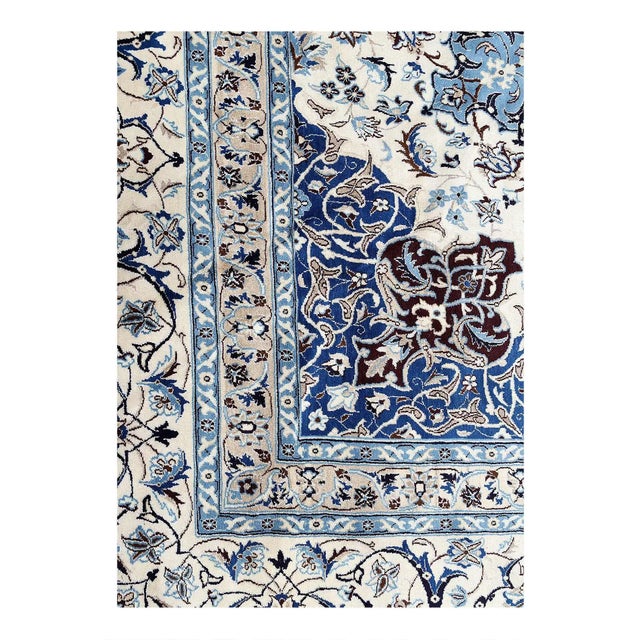 Persian Nain rugs are renowned for their detail and fine use of outlining along the central motifs. Breaking from the...