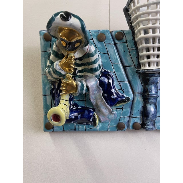 Ceramic panel with 7 tiles of which: 4 characters with Venetian mask and musical instruments and 3 with light points. The...