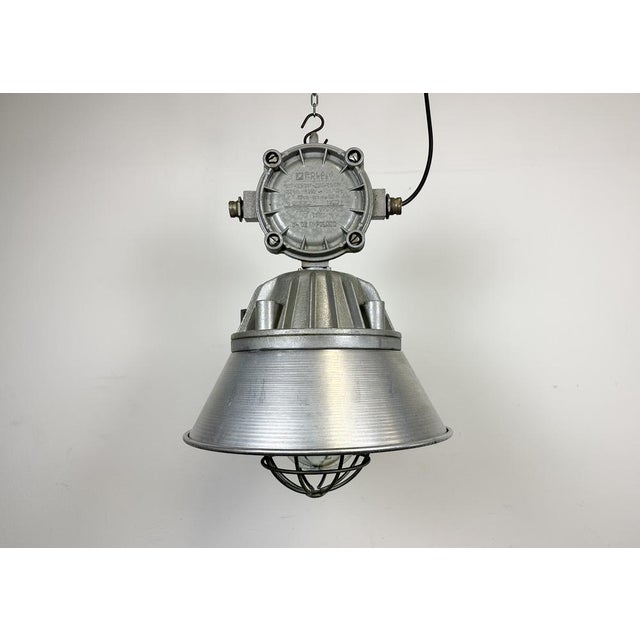 Large industrial factory hanging lamp made by Polam Wilkasy in Poland during the 1970s. It features a cast aluminium body,...