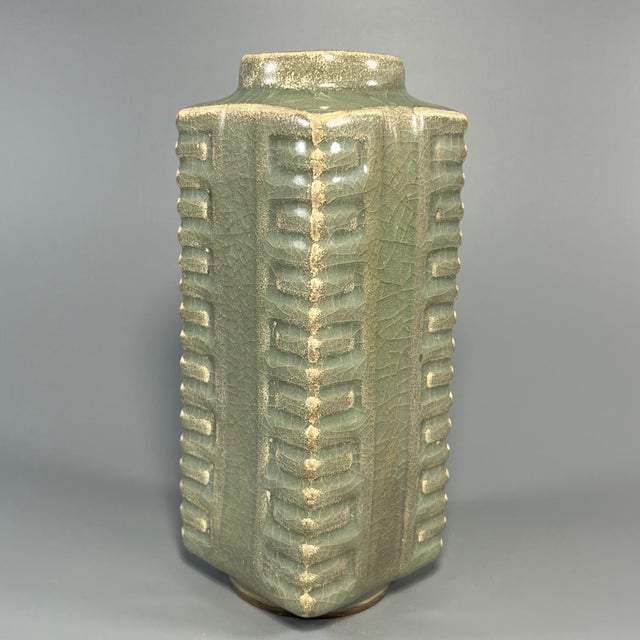 A vintage‑style Chinese Longquan celadon cong‑shape square vase. The exterior is decorated with classic vertical carved...