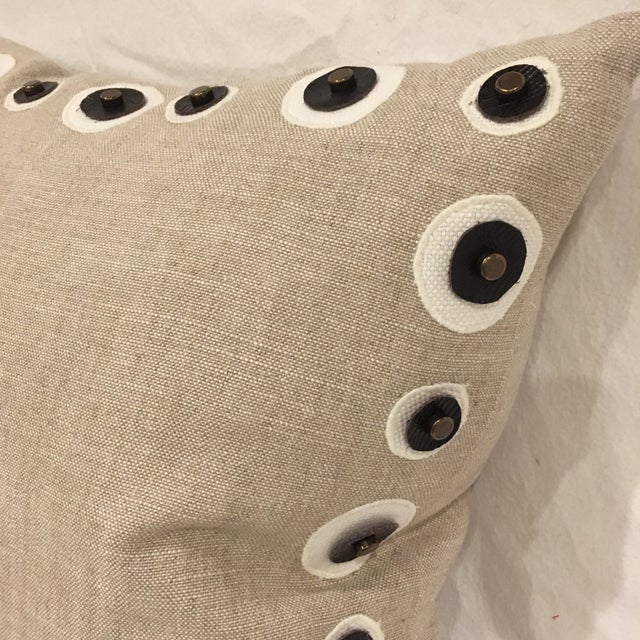 Natural linen toss pillow with brown leather circle detailing, insert included.