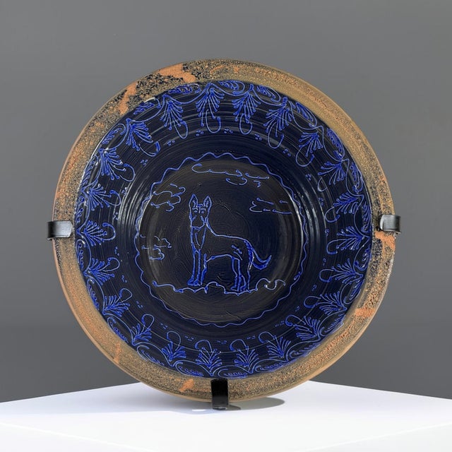 A large Spanish hand-painted earthenware lebrillo bowl executed in the traditional Fajalauza style. The bowl is decorated...