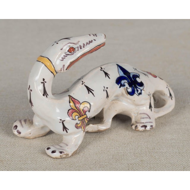A 19th Century French Desvres faience whimsical salamander figurine by Fourmaintraux Freres. Hand-painted in typical...