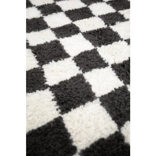 Made-to-order checkerboard hand-knotted rug. Made in Morocco from 100% wool. The classic checkered pattern is softened by...