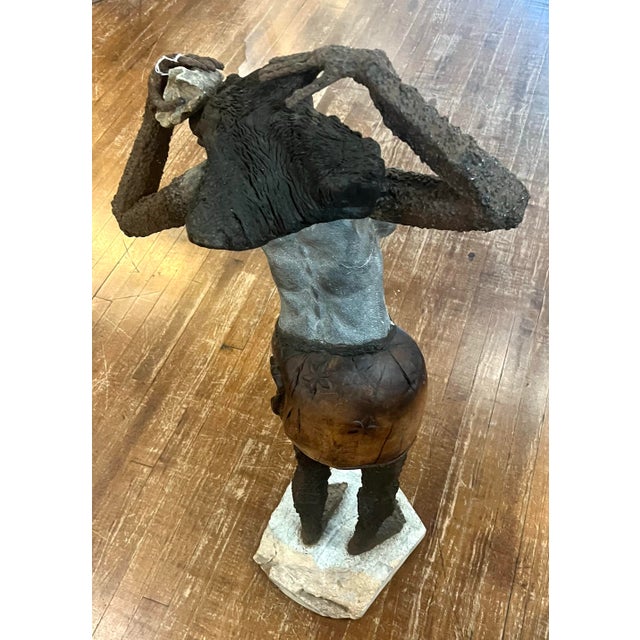 Beautiful sculpture of an African woman carrying a basket on her head. She measures about 42”. She is made from stone,...