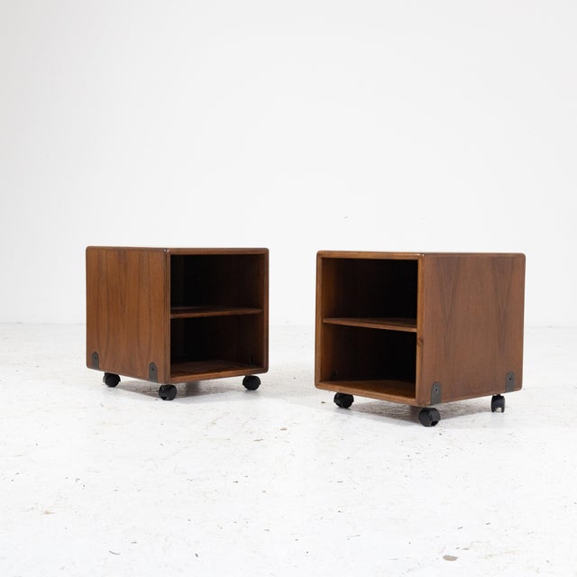 Pair of mobile bedside tables on wheels, characterised by an essential and functional design typical of Italian production...