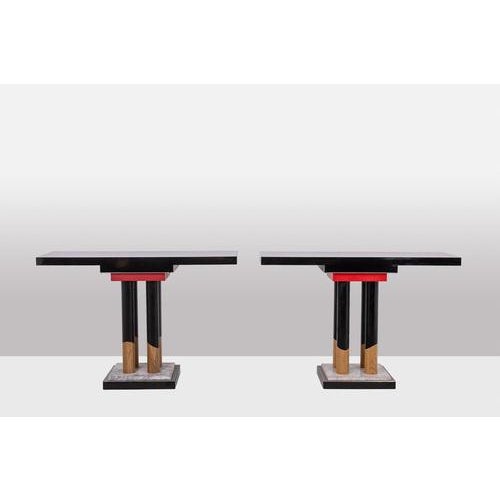 Pair of consoles, in wood and black and red melamine, resting on an iron and white marble base. Circa 1980/90. This piece...