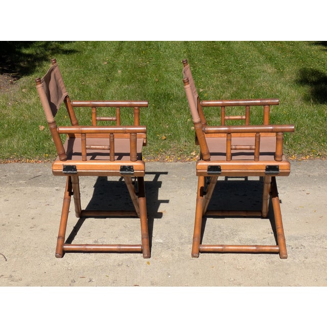 Listed is a pair of vintage Faux Bamboo folding chairs with canvas slings. These high style chairs are good to use as is...