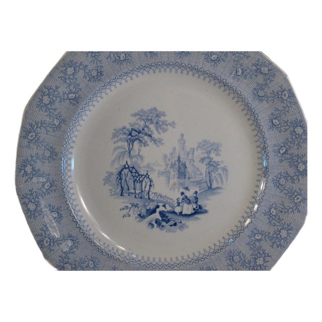 This dinner plate is a stunning example of Victorian-era transferware, featuring a scenic design in blue. Produced by...
