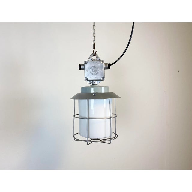 This industrial lamp in aluminium with milky glass was produced by Elektrosvit in former Czechoslovakia during the 1970s ....