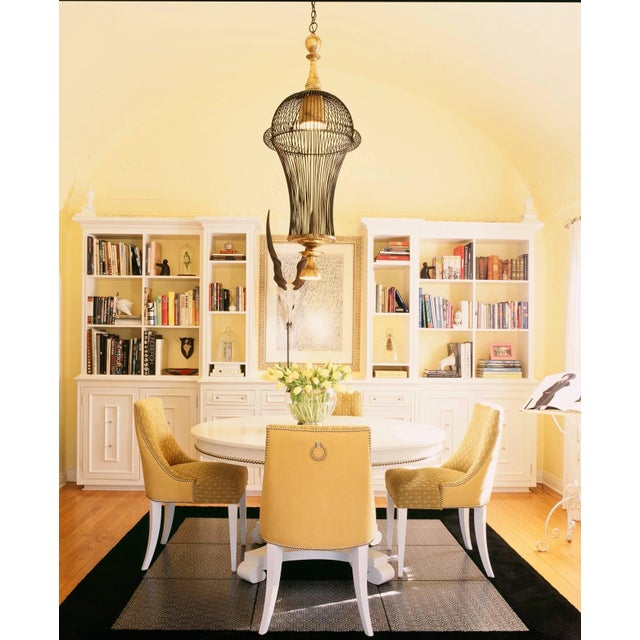 A stunning Modern chandelier reminiscent of a cage, gilt upper and lower light features (come lit at on same switch,)...