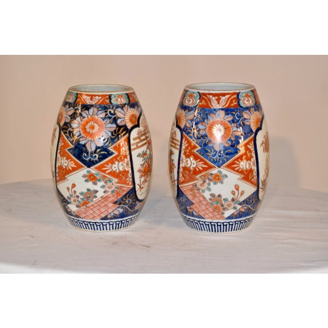 Pair of 19th century Imari vases in an unusual cylindrical shape. Their are two cartouches on each vase depicting a bird...