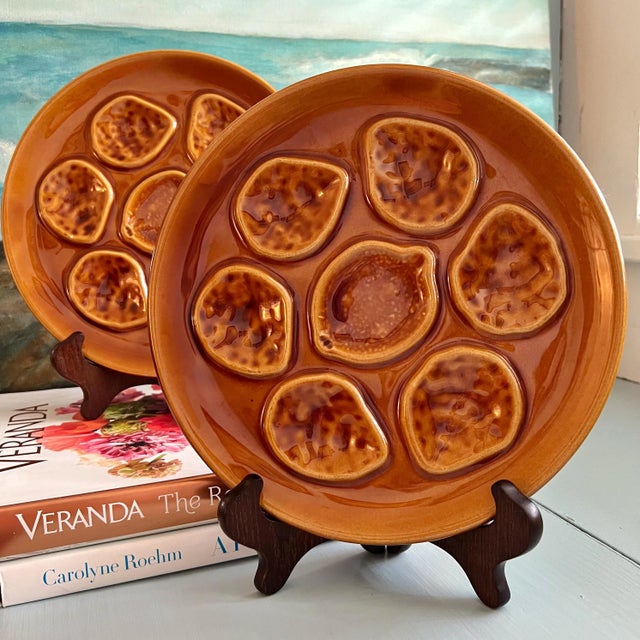 Traditional style oyster plates with a French brown glaze. Plates incorporate 6 wells for oysters and a center well in the...