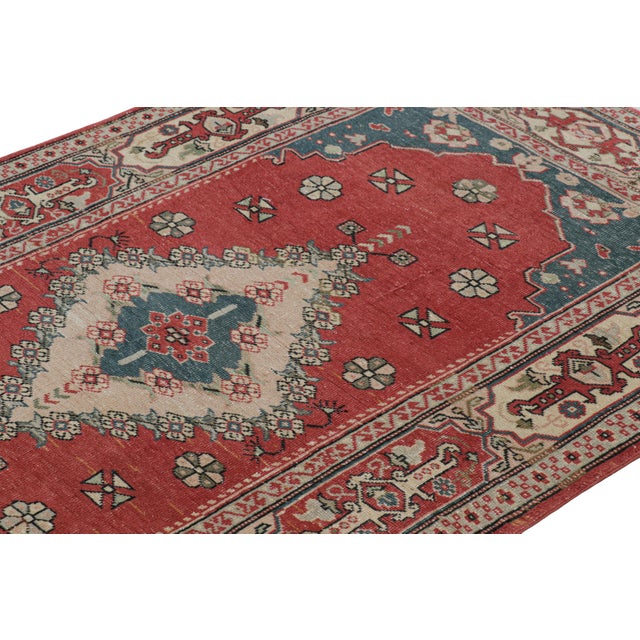Hand-knotted in wool, this 4x7 vintage rug originating from Turkey, circa 1950-1960, is a very special piece, featuring a...