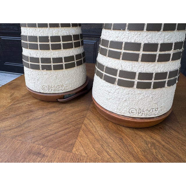 Elevate your interior with this striking pair of monumental Mid-Century Modern table lamps manufactured by the renowned...