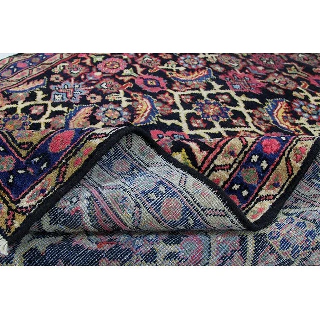 Traditional Old Handwoven Persian Mahal Area Rug featuring an allover design in a black-colored field enclosed in a navy-...
