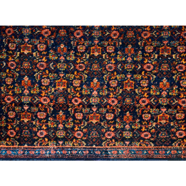 An incredible early 20th century Persian Senneh rug with an all-over trellis floral pattern woven in myriad colors...