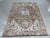 This ivory beige cream white wool rug features a durable hand knotted pile construction. It represents a contemporary...