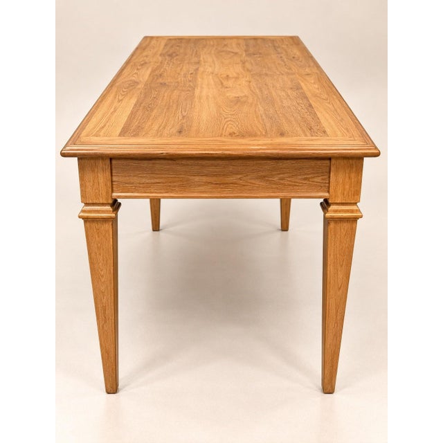 A louis xvi style flat desk in solid oak and oak veneer, fully restored by a workshop. the rectangular top, framed by a...