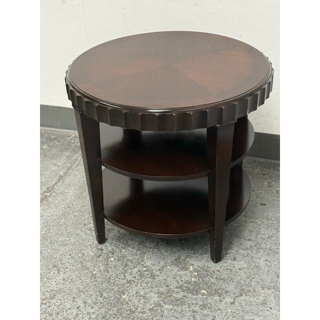 Design Plus Gallery presents a Scallop Edge Tiered Side Table. This round side table is designed with an espresso-toned...