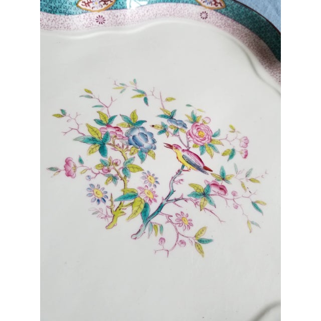 Very unusual antique porcelain serving tray that has original holes in rim to hang it on a wall and antique retailer tag...