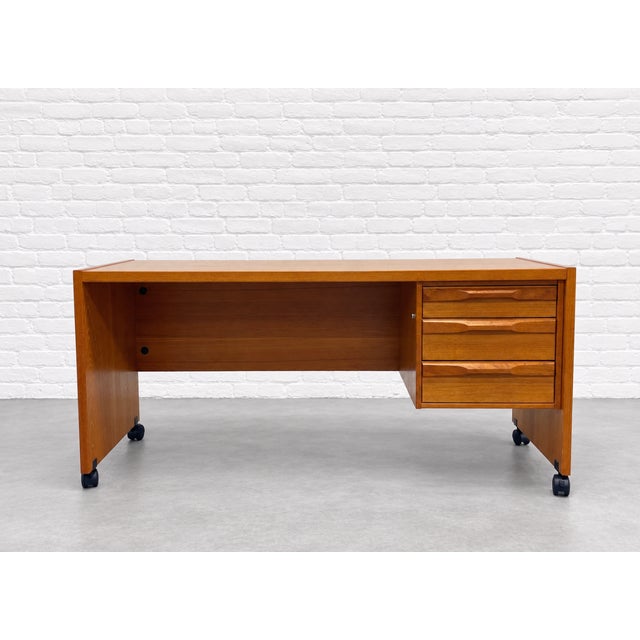 Beautifully crafted Mid Century Modern Teak Danish desk by Denka, Made in Denmark. It features a long, spacious tabletop...