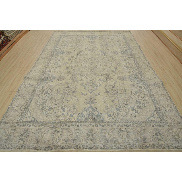 An authentic vintage traditional Tabriz rug hand-knotted with an all-wool pile on a cotton foundation. This oriental rug...