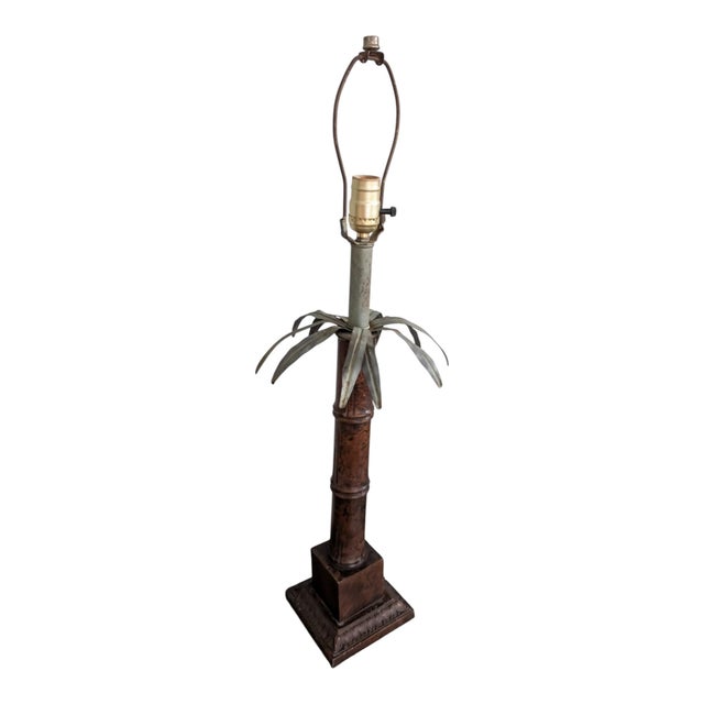 Striking vintage 1970s table lamp featuring a tall faux-bamboo column topped with sculptural metal palm fronds and set on...
