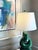 Sculptural ceramic lamp with a fluid, looping form. Rich emerald green glaze with tonal variation. Midcentury modern in...