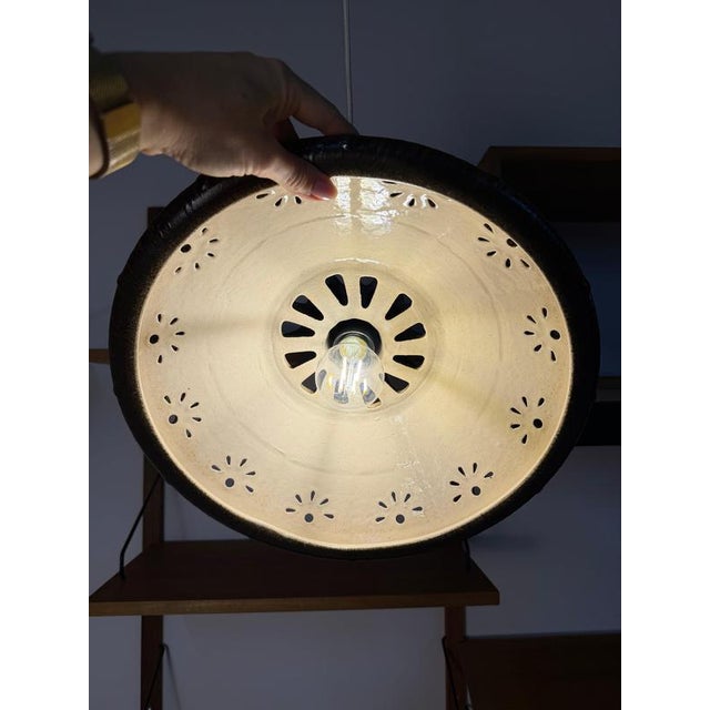 A captivating highlight of west german ceramic art: this funnel-shaped ceramic pendant lamp perfectly embodies the warm,...