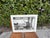 Striking large-format exhibition poster featuring Terry O’Neill’s celebrated photograph of Clint Eastwood relaxing between...