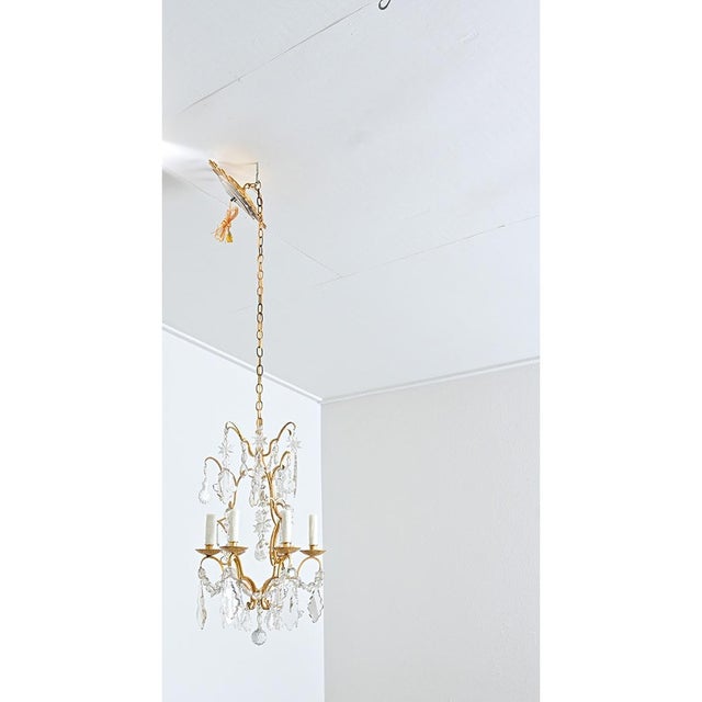 A dazzling French gilt bronze and crystal chandelier from the mid-20th century to illuminate your dining room, foyer, or...