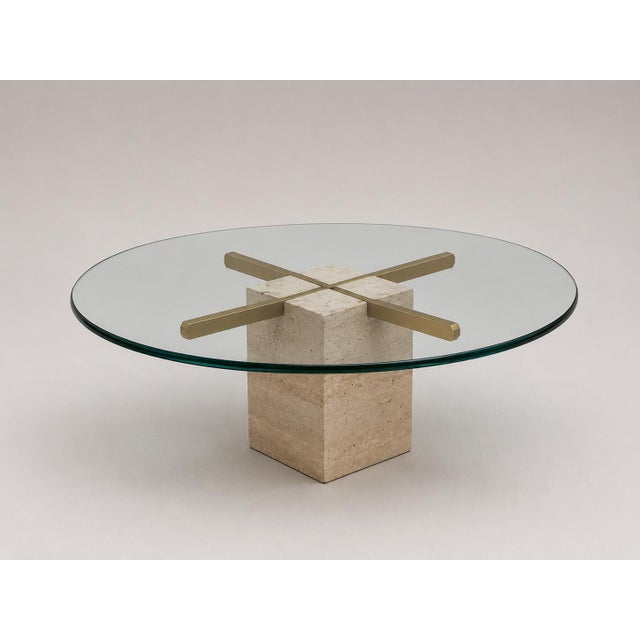 This stylish vintage coffee table combines a thick glass tabletop with an elegant travertine and brass base. The...