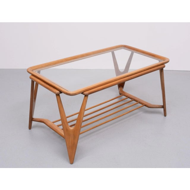 Very nice organic shaped coffee table . Solid Nutwood . Glass top . good condition .