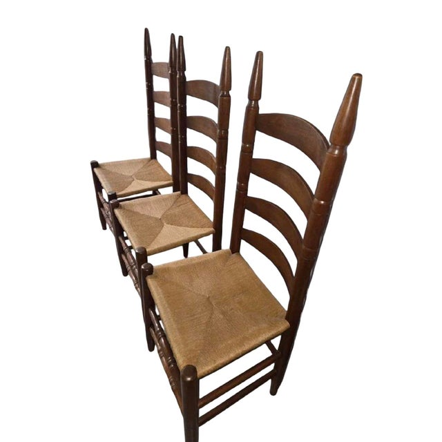Striking set of three vintage American ladder-back dining chairs featuring exceptionally tall, graceful backs, elongated...