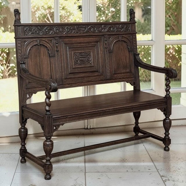 Created in the 19th century during the great European Renaissance Revival, this Dutch carved oak hall bench reflects a...