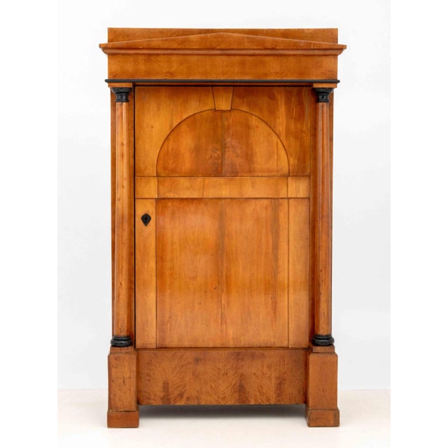 Biedermeier Partial Ebonized Fruitwood Armoire, 19th century, the single door flanked by columns, plaque label "Ex Coll....