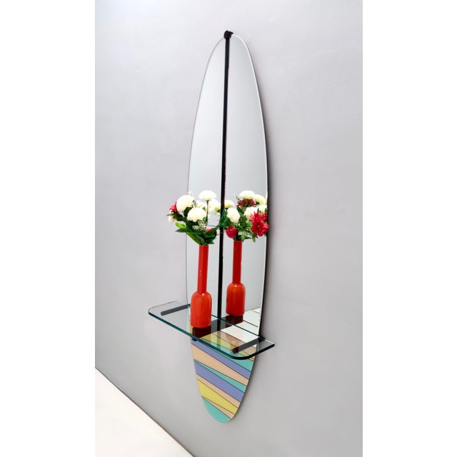 Made in Italy, 1980s. This mirror features a multi-layered beech back, a varnished metal frame, a crystal top and a multi-...