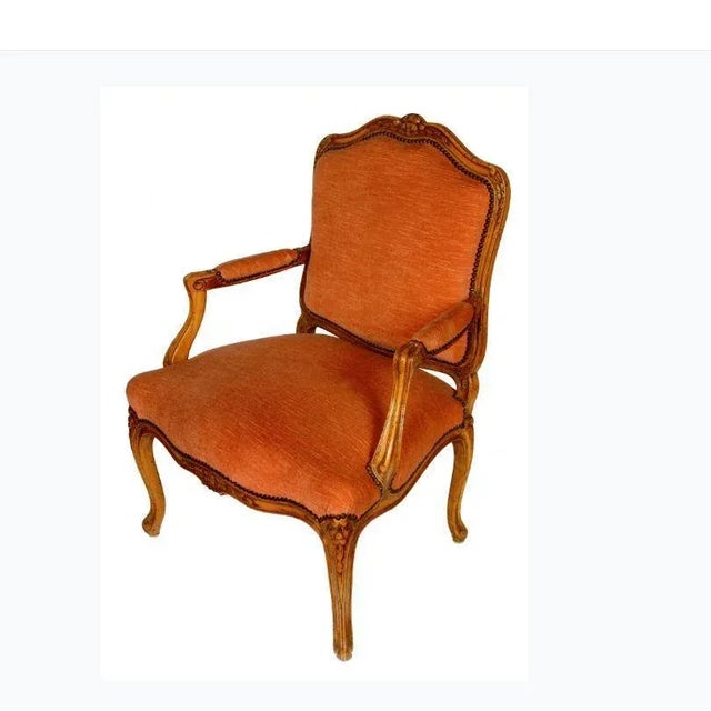 A pair of French upholstered Louis XV style fauteuils with brass nailhead trim, circa 1940.