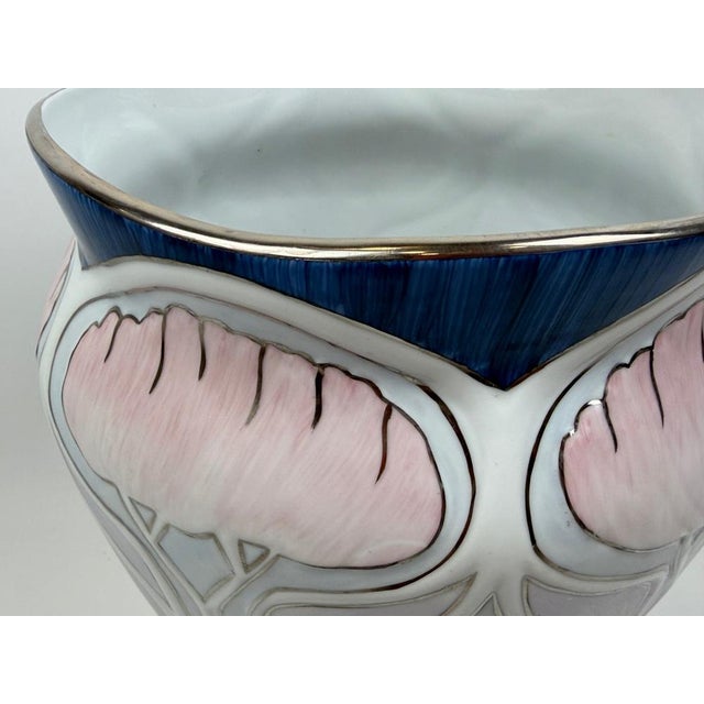 Porcelain vase with an oval shape, with diagonal wide stripes in the shape of wings, white glaze. German production from...