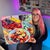 This oil painting presents a vibrant still life composition featuring an abundance of fresh fruits, including...