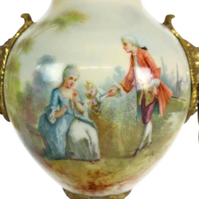 An exquisite antique French Sevres style urn lamp, crafted circa 1890, featuring a finely painted porcelain body mounted...