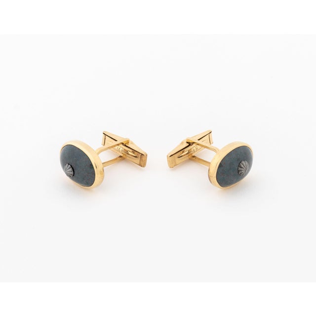 Pair of Bloodstone and 14K Yellow Gold Cufflinks, adorned with two bezel set oval bloodstone chalcedony cabochons weighing...