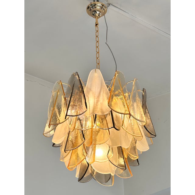 Contemporary and luxury Murano glass chandelier. “Rondini” traditional elements in Murano glass poured over a mold from a...