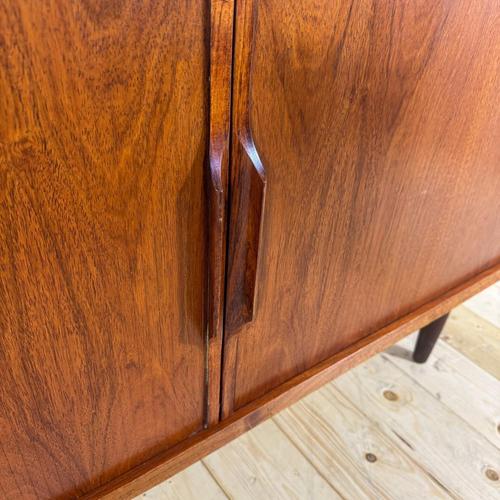 This teak sideboard with retractable doors is a refined example of Mid-Century Modern Scandinavian design, dating back to...