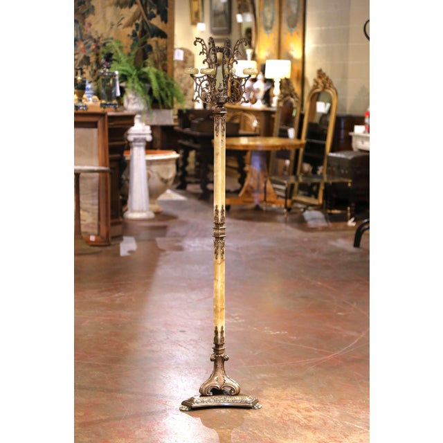 This antique carved onyx and brass hall tree was crafted in France, circa 1920. Standing on an intricate triangular molded...